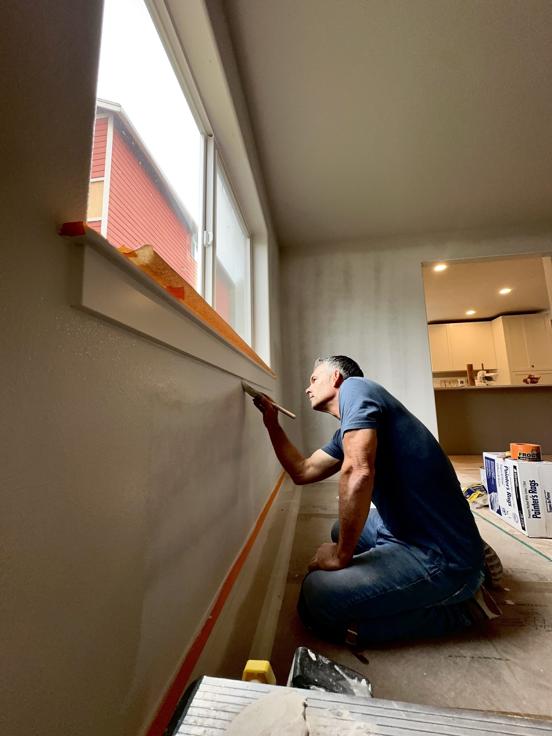 Wolf Build and Restore contractor painting a repaired ceiling during an insurance restoration project in Bellingham WA.